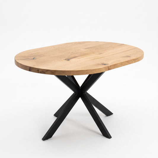 An oval wooden dining table with a natural oak finish and a black metal X-shaped base, shown on a clean white background.