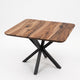 A square dining table with a rich brown wood grain top and a black metal X-shaped pedestal base, shown on a clean white background.